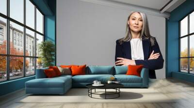 confident asian businesswoman with grey hair and crossed arms isolated on grey Wall mural