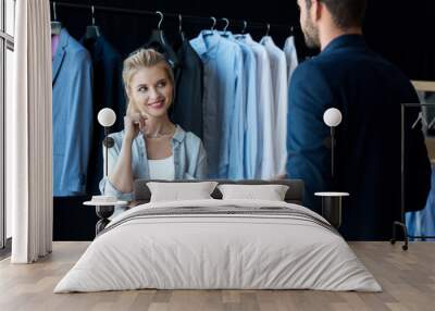 couple choosing suit in boutique Wall mural