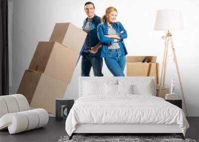 Couple moving cardboard boxes on hand cart isolated on white Wall mural