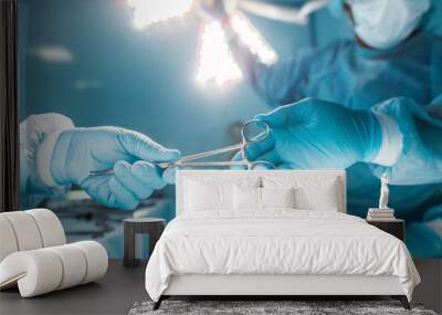 cropped image of nurse passing medical scissors to surgeon Wall mural