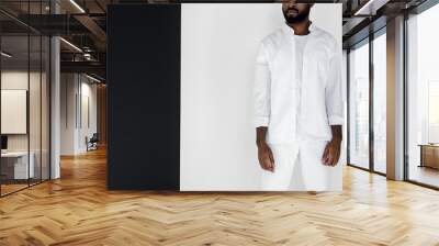 cropped image of stylish african american man standing in white clothes near black and white wall Wall mural