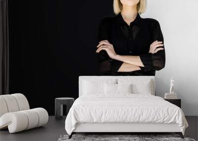 cropped image of stylish blonde woman in black clothes standing with crossed arms Wall mural