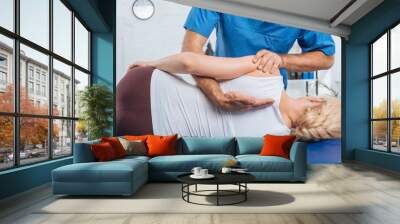 cropped shot of chiropractor massaging back of patient that lying on massage table in hospital Wall mural