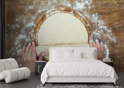 cropped shot of female hands rolling pizza dough with rolling pin Wall mural