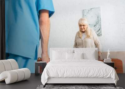 cropped shot of male nurse and senior woman playing table football Wall mural