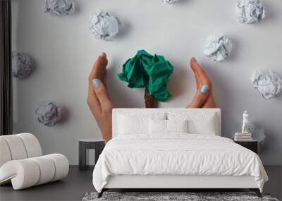 cropped shot of woman covering crumpled papers in shape of tree on white surface Wall mural