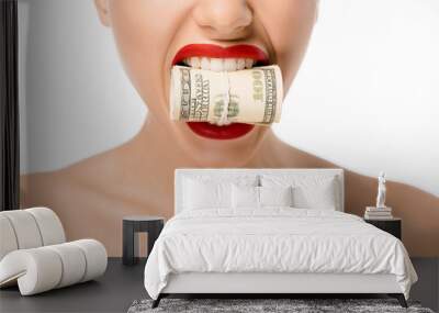 cropped shot of woman holding rolled dollar banknotes in teeth isolated on white Wall mural