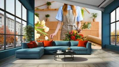 cropped shot of young florist in apron working with flowers Wall mural