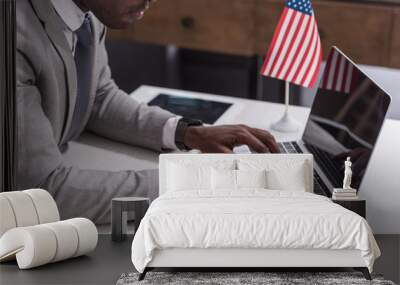 Cropped view of african american businessman typing on laptop keyboard Wall mural