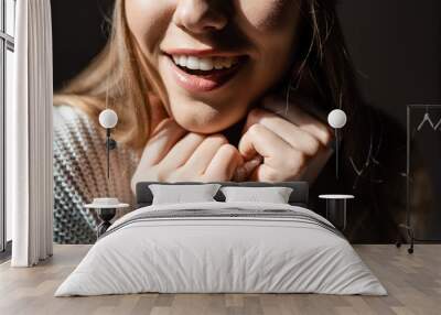 cropped view of beautiful smiling girl in white sweater Wall mural