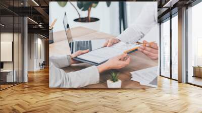 cropped view of businessman giving compensation claim form to woman at workplace Wall mural