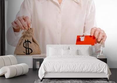 cropped view of businesswoman weighing house model and moneybag isolated on white, mortgage concept Wall mural