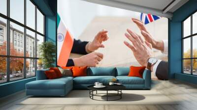 cropped view of diplomats gesturing near flags of india and united kingdom Wall mural