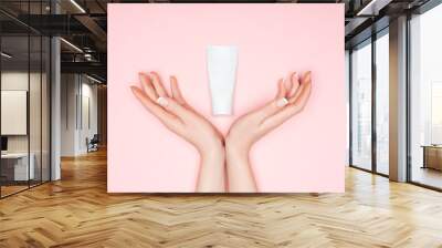 cropped view of female hands with hand cream isolated on pink Wall mural