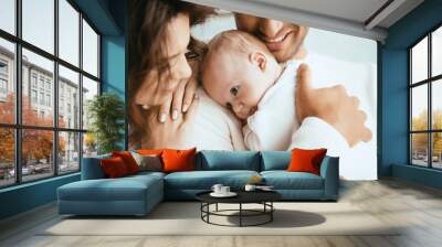 cropped view of happy man holding adorable baby near smiling wife Wall mural