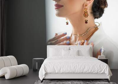 cropped view of indian bride touching necklace on white Wall mural