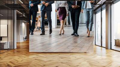 cropped view of multicultural businessmen and businesswomen walking in office Wall mural