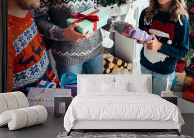 cropped view of parents holding gifts near happy daughter and dog on christmas Wall mural