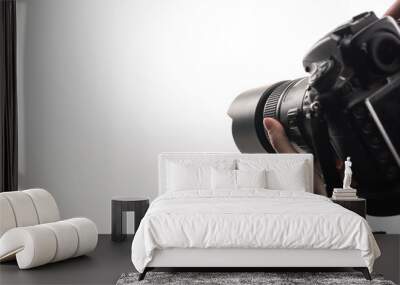 cropped view of photographer working with digital camera isolated on white Wall mural