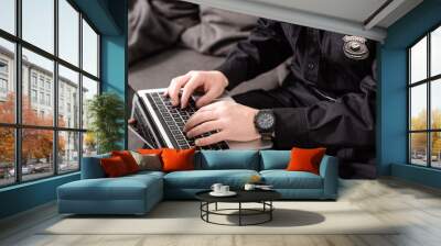 cropped view of policeman typing on laptop keyboard Wall mural