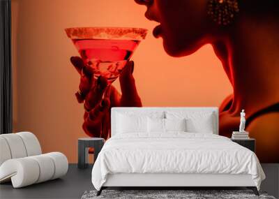 cropped view of woman drinking margarita cocktail on orange Wall mural