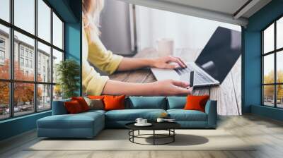 cropped view of woman holding credit card and using laptop Wall mural