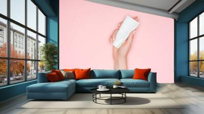 cropped view of woman holding hand cream isolated on pink with copy space Wall mural