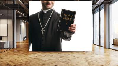 cropped view of young catholic priest showing holy bible isolated on white Wall mural