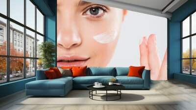 cropped view of young woman applying face cream isolated on grey Wall mural