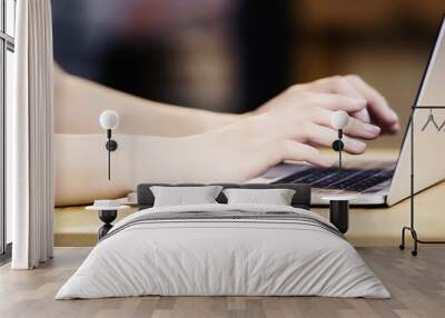 cropped view of young woman typing on laptop in cafe Wall mural