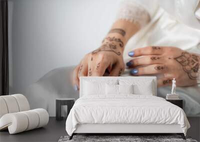 cropped view of young woman with mehndi on white Wall mural