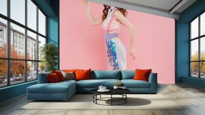 doll concept, attractive young woman with wavy hair posing and gesturing while standing on pink background, fashion model in stylish outfit, femininity, doll pose Wall mural