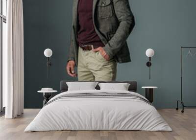 elegant male model posing in beige pants and tweed jacket, on grey Wall mural