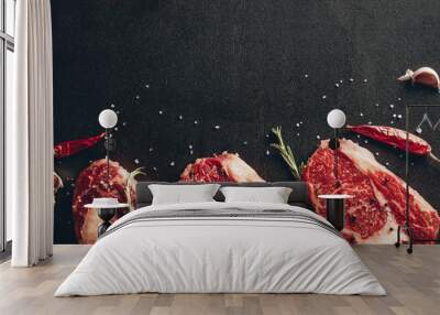 elevated view of raw meat steaks and spices on surface in kitchen Wall mural