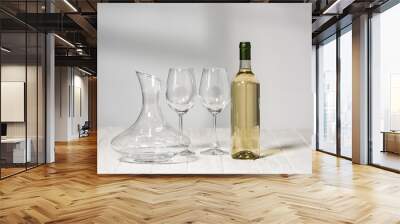 empty wine glasses, bottle of wine and jug on wooden surface in restaurant Wall mural