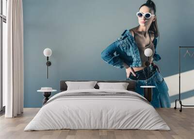 fashionable brunette model posing in denim style and sunglasses Wall mural