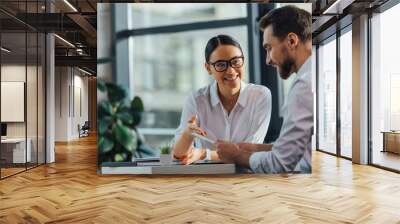 female asian translator working working with smiling businesswoman Wall mural