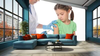 Female pediatrician doing vaccine injection to child isolated on white Wall mural