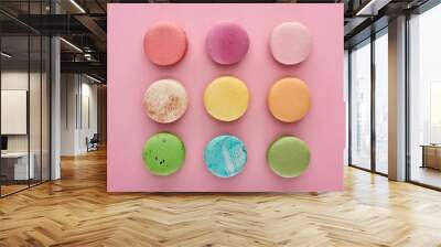 flat lay with multicolored delicious French macaroons on pink background Wall mural