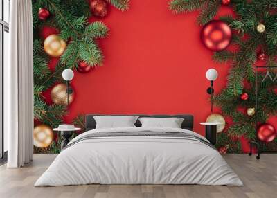 flat lay with pine tree branches with red and golden christmas balls isolated on red Wall mural