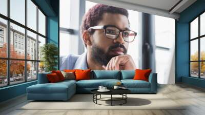 Focused african american businessman in eyeglasses looking at computer monitor in office, banner Wall mural