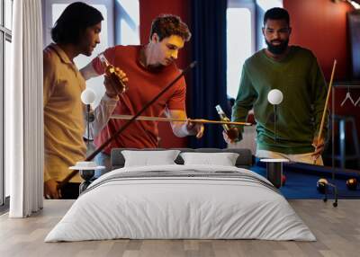 Friends play billiards in a casual setting. Wall mural