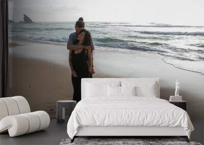 full length of happy man hugging tattooed girlfriend in dress near ocean in portugal. Wall mural