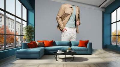 full length of stylish man posing with hand in pocket on grey Wall mural