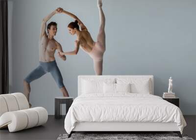 full length of young cheerful ballet dancer performing ballet dance with ballerina on grey Wall mural