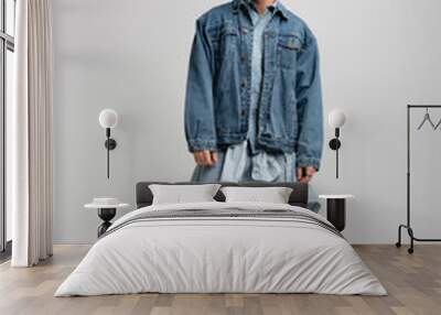 full length of young man in denim outfit posing and looking at camera on grey. Wall mural