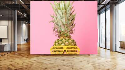 funny and tasty pineapple in sunglasses on pink background Wall mural