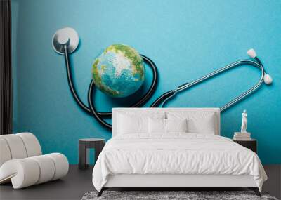 Globe and stethoscope on blue background, world health day concept Wall mural