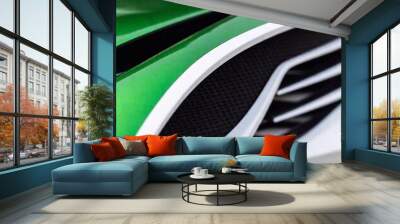 green car with a black and white stripes on the background of the car Wall mural