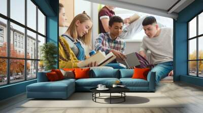 Group of multicultural high school teenage high school students doing homework during school break Wall mural